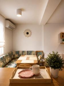 a living room with a table and a couch at Garden Oasis Apartment in Veles