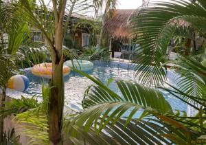a swimming pool with two inflatables in a resort at Retreat Cameroon BASTOS in Yaoundé