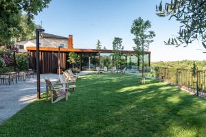 a lawn with chairs and a pavilion at Borgo Baccile by Vini Fantini in Crecchio