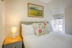 a bedroom with a bed and a lamp on a night stand at 3 Bed in Dornoch oc-o44869 in Dornoch