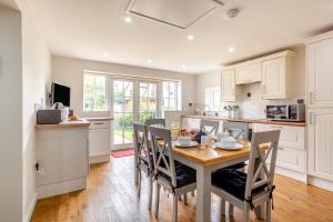 a kitchen with a table and chairs in a kitchen at 3 Bed in Dornoch oc-o44869 in Dornoch