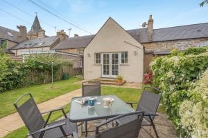 a table and chairs in the backyard of a house at 3 Bed in Dornoch oc-o44869 in Dornoch