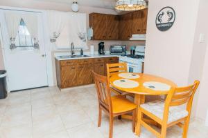 a kitchen with a wooden table and two chairs at NEW Desert Bloom Hideaway in Green Valley