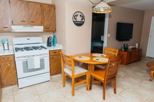 a kitchen with a table and chairs and a stove at NEW Desert Bloom Hideaway in Green Valley