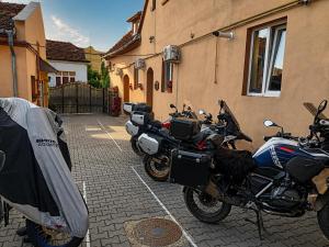 a couple of motorcycles parked next to a building at Pensiunea Casa Sighisoreana in Sighişoara
