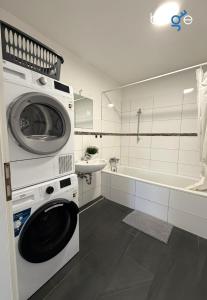 a washing machine in a bathroom with a sink at BEGE APARTMENTS WorkSpace in Marl