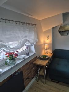 a living room with a table and a couch and a window at Radiowa mini in Warsaw +24 photos