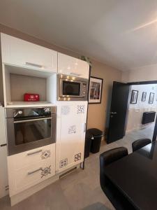 a kitchen with a microwave and a stove at Studio Magritte 156 in Boussu