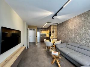 a living room with a couch and a table at Apartment Sonata in Varna City