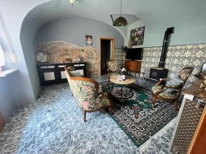 a living room with chairs and a fireplace at Il Rustico Guesthouse in Lessona