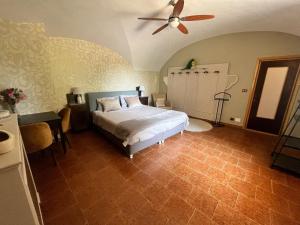a bedroom with a bed and a ceiling fan at Il Rustico Guesthouse in Lessona +93 photos