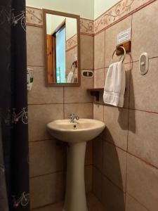 a bathroom with a sink and a mirror at Point Break Santa Teresa in Santa Teresa Beach +96 photos