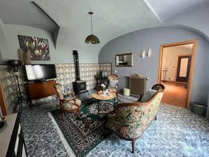 a living room with a table and chairs at Il Rustico Guesthouse in Lessona