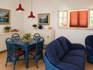 a living room with a table and chairs at Villa Adele Monopoli,Puglia in Faccia di Trippa