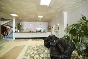 a living room with a leather chair and a counter at Gostinitsa Rossia in Novomoskovsk