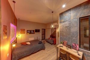 a bedroom with a bed and a desk in a room at Cachette Secrète in Bourgoin