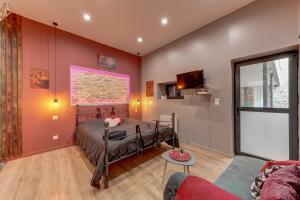 a bedroom with a bed and a living room at Cachette Secrète in Bourgoin