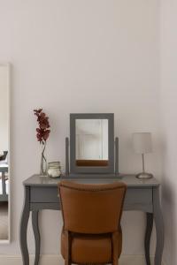 a dressing table with a mirror and a chair at Park Crescent - Quaint Victorian Home With Free Parking in York