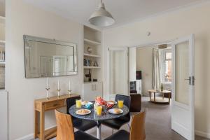 a dining room with a table with food on it at Park Crescent - Quaint Victorian Home With Free Parking in York