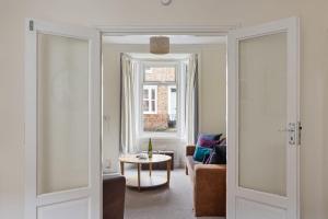 a living room with a couch and a table at Park Crescent - Quaint Victorian Home With Free Parking in York