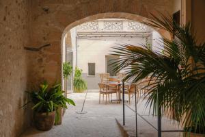 an archway with a table and chairs in a room at Bytra Boutique Hotel - Adults Only in Petra