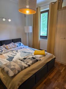 a large bed in a bedroom with a lamp at Dom na Wynajem Gdynia Grabówek in Gdynia