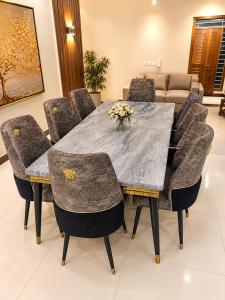 a dining room with a marble table and chairs at Guest Villa in Lāsezai