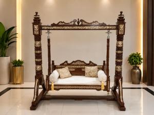 an ornate wooden bed with pillows in a room at Guest Villa in Lāsezai +13 photos