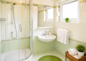 a bathroom with a shower and a sink and a mirror at Apartments Tonći and Iris in Primošten