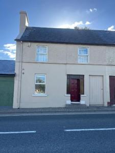 a white house on the side of a street at Bayview in Ballysadare