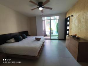 a bedroom with a bed and a ceiling fan at Top Pool Condo in Ixtapa's Hotel Area in Ixtapa