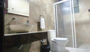 a bathroom with a sink and a toilet and a shower at Top Pool Condo in Ixtapa's Hotel Area in Ixtapa +10 photos