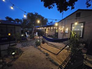 a hammock in front of a house at night at 21 Cozy Home in the Heart of the City in Stockton