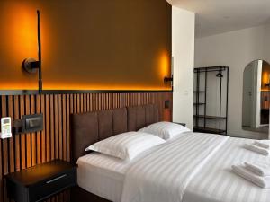 a bedroom with a large bed and a mirror at Lumen - Bright Stay in Bucharest in Bucharest