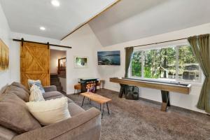 a living room with a couch and a piano at Maltby modern log cabin #2307 in Big Bear City