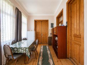 a dining room with a table and chairs and a refrigerator at panorama lasuriashi in Lasuriashi