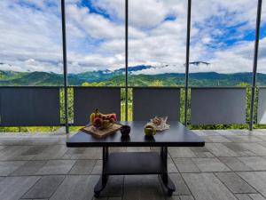 a table with fruit on it in front of a window at panorama lasuriashi in Lasuriashi +3 photos