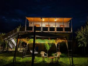 a tree house with a table and chairs in the yard at panorama lasuriashi in Lasuriashi
