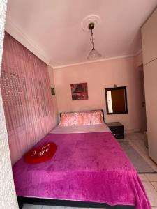 a bedroom with a bed with a pink bedspread at Olympus View - Valentina in Litochoro