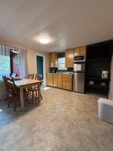 a kitchen with a table and chairs in a room at Forest & Lake PEI Cottages in Murray Harbour