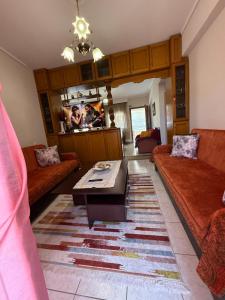 a living room with a couch and a coffee table at Olympus View - Valentina in Litochoro