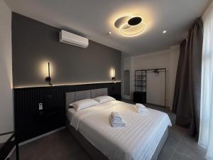 a bedroom with a bed with two towels on it at Lumen - Bright Stay in Bucharest in Bucharest +30 photos