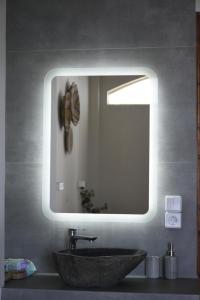 a bathroom with a sink and a mirror at Venus Studios in Vlachata +21 photos