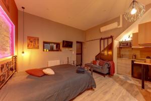 a bedroom with a large bed in a room at Cachette Secrète in Bourgoin +26 photos