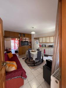 a living room with a red couch and a table at Olympus View - Valentina in Litochoro