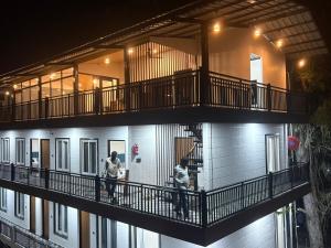 two people walking on a balcony of a building at Hotel Velvet Vista in Rishīkesh