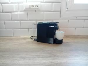 a coffee maker sitting on the floor in a kitchen at La casa de Verde in Péran Triovasálos