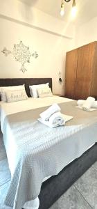 a bedroom with two beds with white sheets at Julsun apartment in Olympic Beach