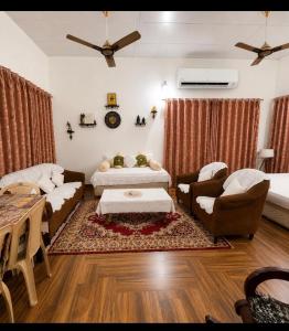 a living room with two couches and a table at White View Park in Dharmsāla