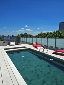 a swimming pool on the roof of a building at Pleno Palermo Soho in Buenos Aires +50 photos